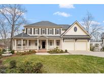 Charming two-story home featuring a welcoming front porch and a two-car garage at 302 Edinburgh Dr, Cary, NC 27511