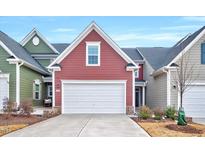 Exterior elevation of a two-story home featuring a white garage door and a red facade at 408 Judge Ct, Durham, NC 27703