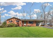 Charming brick home featuring a well-manicured lawn and a convenient carport at 503 Sherwood Dr, Sanford, NC 27330