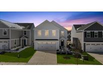 Beautiful two-story home with a two car garage and well maintained lawn and landscaping at 669 Impala Trce, Wendell, NC 27591