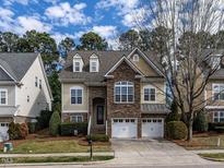 Charming two-story home featuring a stone facade and a two-car garage at 1028 Dotson Way, Apex, NC 27523