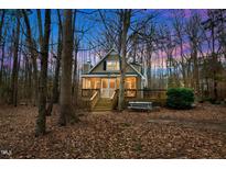 Charming home with a screened porch and wooden deck surrounded by trees at 107 Smallwood Ct, Hillsborough, NC 27278