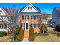 Charming two-story brick home featuring classic shutters and landscaped front yard at 112 Bally Shannon Way, Apex, NC 27539
