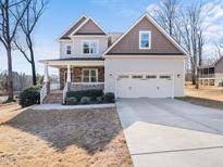 Charming two-story home featuring a covered porch and attached two-car garage at 115 Lockamy Ln, Youngsville, NC 27596