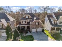 Charming brick and siding home with a two-car garage and well-manicured lawn at 12345 Beestone Ln, Raleigh, NC 27614