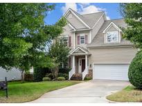 Charming two-story home with a well-manicured front yard and a two-car garage at 1309 Trailing Rose Ct, Wake Forest, NC 27587