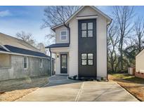 Modern two-story home with a concrete driveway and a combination of white and black accents at 1410 Joe Louis Ave, Raleigh, NC 27610