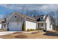 Charming one-story home with light siding, a dormer window, manicured landscaping and an attached two car garage at 1413 Buxus Ct, Fuquay Varina, NC 27526