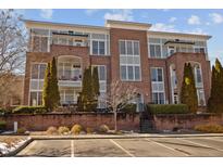 Charming brick condo building with balconies, mature landscaping, and convenient parking at 201 Finsbury St # 302, Durham, NC 27703