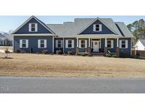 Charming two-story home featuring blue siding, white trim and inviting front porch at 24 Blackberry Ct, Benson, NC 27504