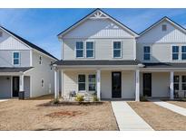 Charming two-story townhouse with a welcoming front porch and well-maintained lawn at 3010 Garner Rd # 102, Raleigh, NC 27610