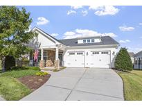 Charming home featuring a well-manicured lawn, stone accents, and a two-car garage at 338 Wildwind Dr, Chapel Hill, NC 27516