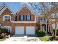 Charming brick two-story home featuring a two-car garage, manicured lawn, and inviting entrance at 3924 Sunset Maple Ct, Raleigh, NC 27612