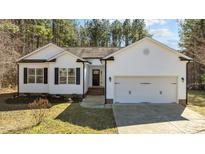 Charming single Gathering home featuring a 2-car garage, black shutters and attractive landscaping at 40 Paddle Wheel Ct, Franklinton, NC 27525