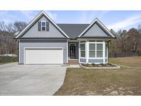 Charming single Gathering home featuring a two car garage, bay window, and well manicured landscaping at 4001 Burlington Mills Rd, Wake Forest, NC 27587