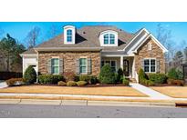 Charming single-Gathering home with stone facade, dormer windows, and manicured landscaping at 44 Ashwood Dr, Chapel Hill, NC 27516