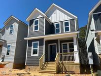 Charming two-story home featuring gray siding, white trim, and inviting front porch at 502 Yeowell Dr, Chapel Hill, NC 27514