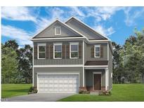 Two-story home with gray siding, brown shutters, white garage door, and well-manicured lawn at 52 Commons Cir, Clayton, NC 27520