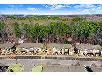 Scenic aerial view of townhomes backing up to wooded area and beautiful landscape at 736 Wickham Ridge Rd, Apex, NC 27539
