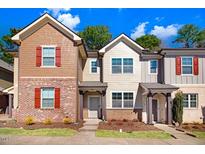Charming townhomes featuring brick and siding exteriors and colorful shutters under a bright sky at 736 Wickham Ridge Rd, Apex, NC 27539