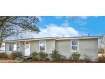 Charming single-story home with neutral siding, white trim, and a well-maintained front yard at 9053 County Line Rd, Rocky Mount, NC 27803