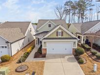 Charming home featuring a two-car garage and a welcoming covered entry at 124 Currituck Ln, Durham, NC 27703