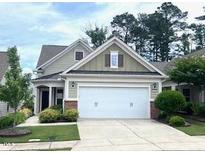 Charming home featuring a two-car garage and well-manicured landscaping at 124 Currituck Ln, Durham, NC 27703