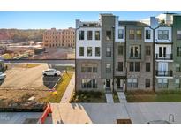Modern townhome with brick and siding facade, showcasing contemporary design and inviting curb appeal in a residential area at 1259 Shaw View Alley # 201, Raleigh, NC 27601