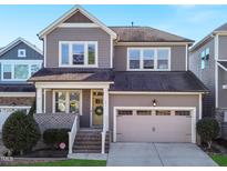 Charming two-story home with a well-manicured lawn, a two-car garage, and inviting front porch at 171 Old Piedmont Cir, Chapel Hill, NC 27516