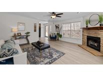 Bright living room featuring a stone fireplace, large windows, and modern decor at 180 Carolina Ridge Rd, Pittsboro, NC 27312