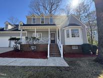 Charming two-story home featuring a cozy front porch and a neatly landscaped yard at 208 Lawrence Rd, Cary, NC 27511