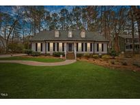 Charming one-story home with a manicured lawn and beautiful landscaping at 2104 Millpine Dr, Raleigh, NC 27614