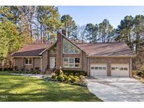 Charming brick home features a large front yard and attached two-car garage at 2520 Summit Ln, Creedmoor, NC 27522