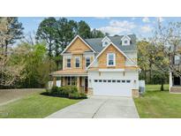 Charming two-story home featuring a two-car garage, inviting front porch, and professionally landscaped yard at 2901 Landing Falls Ln, Raleigh, NC 27616