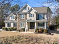 Charming two-story home with stone accents and a welcoming front porch at 324 Stearns Way, Wake Forest, NC 27587