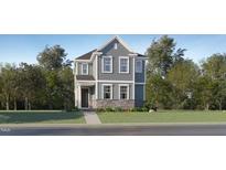 Charming two-story home featuring stone accents and traditional architectural details at 328 Canyon Spring Trl, Wake Forest, NC 27587