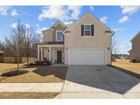 Two-story home with neutral siding, a two-car garage, and a well-manicured lawn in a suburban setting at 40 Glendavis Hollow Dr, Franklinton, NC 27525