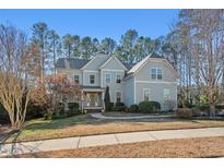 Charming two-story home with beautiful landscaping, neutral siding, and a welcoming entrance at 504 Crooked Pine Dr, Cary, NC 27519