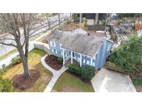 Charming home featuring a well-maintained yard, inviting walkway, and classic architectural details at 5412 Farley Dr, Raleigh, NC 27609