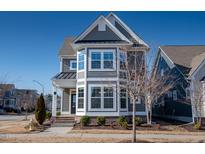 Charming two-story home with gray siding, white trim, and a well-maintained front yard at 5501 Advancing Ave, Raleigh, NC 27616