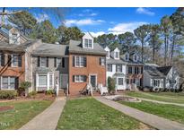 Charming townhomes with varied facades and well-manicured lawns create inviting curb appeal at 6036 Epping Forest Dr, Raleigh, NC 27613