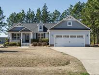 Well-maintained exterior of a beautiful home with an attached two-car garage and manicured lawn at 66 Shetland Ln, Smithfield, NC 27577