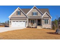 Charming single-Gathering home with a two-car garage and craftsman-style details on a sunny day at 75 Harvest View Way, Franklinton, NC 27525