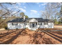 Charming single-story home with a well-maintained yard and inviting front porch at 7722 Nc 27 W, Lillington, NC 27546