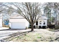 Charming single-story home with a well-manicured lawn and attached two-car garage at 8 Weeping Beech Way, Durham, NC 27713