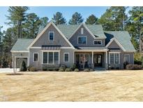 Charming two-story home featuring a beautifully landscaped front yard and traditional architectural details at 1520 Grand Willow Way, Raleigh, NC 27614
