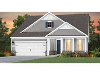 Charming two-story home with gray siding, white trim, a two-car garage and manicured landscaping at 1808 Angelonia Way, Fuquay Varina, NC 27526