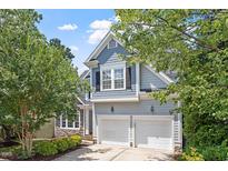 Charming two-story home featuring a two-car garage and well-maintained landscaping at 211 Candia Ln, Cary, NC 27519