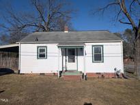 Charming single-story home with white siding, green trim, and a cozy front porch at 2129 Baltic Ave, Durham, NC 27707