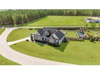 Expansive aerial view of home with a large lawn, play set and surrounding greenery at 29 Alban Row, Fuquay Varina, NC 27526